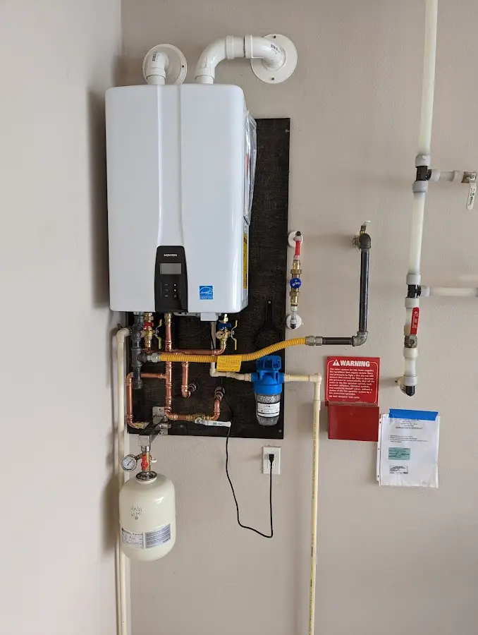 Professional plumber installing copper piping in a Glen Raven home